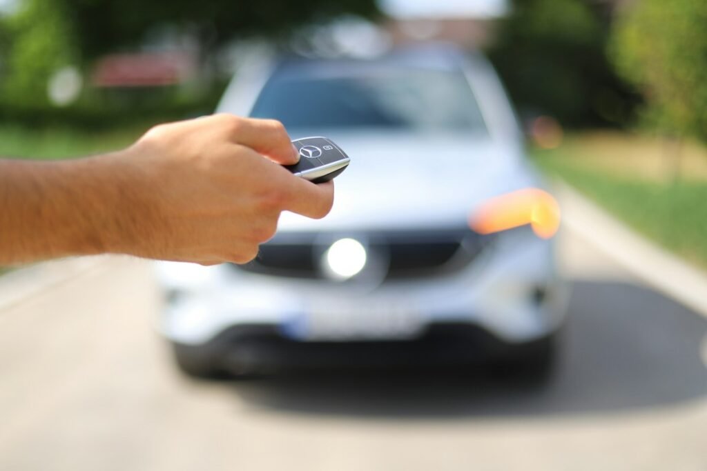 Driver using a car key fob – automotive locksmith and car key replacement